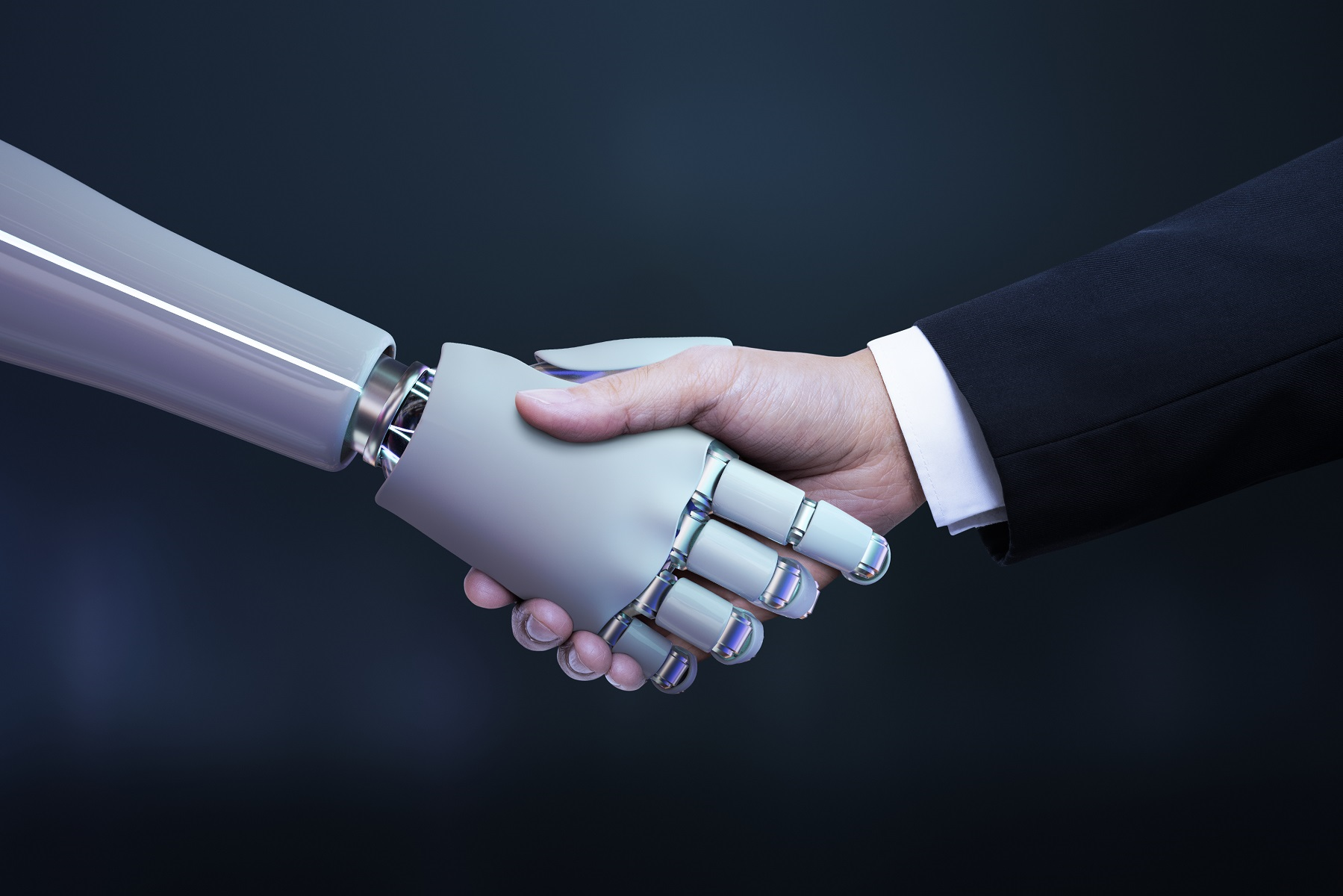 Mão humana e de um robô se cumprimentando.
